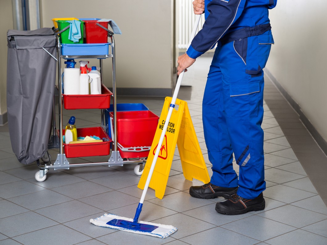 bigstock-Janitor-With-Broom-Cleaning-Of-113497175